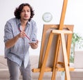 Young handsome man enjoying painting at home Royalty Free Stock Photo