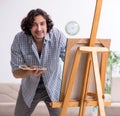 Young handsome man enjoying painting at home Royalty Free Stock Photo