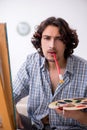 Young handsome man enjoying painting at home Royalty Free Stock Photo