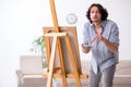 Young handsome man enjoying painting at home Royalty Free Stock Photo