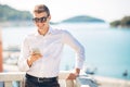 Young handsome man enjoying stay at luxury resort hotel with panoramic view on the sea Royalty Free Stock Photo