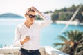 Young handsome man enjoying stay at luxury resort hotel with panoramic view on the sea Royalty Free Stock Photo