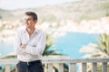 Young handsome man enjoying stay at luxury resort hotel with panoramic view on the sea Royalty Free Stock Photo