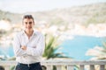 Young handsome man enjoying stay at luxury resort hotel with panoramic view on the sea Royalty Free Stock Photo