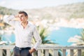 Young handsome man enjoying stay at luxury resort hotel with panoramic view on the sea Royalty Free Stock Photo