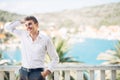 Young handsome man enjoying stay at luxury resort hotel with panoramic view on the sea Royalty Free Stock Photo