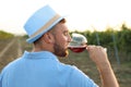 Young handsome man enjoying wine at vineyard Royalty Free Stock Photo