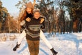 A young handsome man of European appearance and a young Asian girl in a park on the nature in winter. A Royalty Free Stock Photo