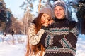 A young handsome man of European appearance and a young Asian girl in a park on the nature in winter Royalty Free Stock Photo