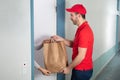 Man Giving Paper Bag To Woman Royalty Free Stock Photo
