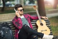 Young handsome man with headphones listening to music in a park Royalty Free Stock Photo