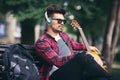 Young handsome man with headphones listening to music in a park Royalty Free Stock Photo