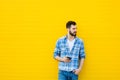 Young handsome man with headphones on yellow wall Royalty Free Stock Photo