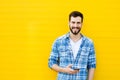Young handsome man with headphones on yellow wall Royalty Free Stock Photo