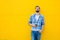 Young handsome man with headphones on yellow wall Royalty Free Stock Photo