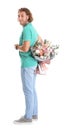 Young handsome man hiding beautiful flower bouquet behind his back