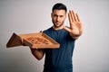 Young handsome man holding delivery box with delicious Italian pizza over white background with open hand doing stop sign with Royalty Free Stock Photo