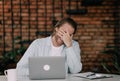 young handsome man laughing while sitting near laptop after watching funny content Royalty Free Stock Photo