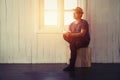 Young handsome man looking out his window at home in the room al Royalty Free Stock Photo