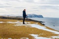 Young handsome man looking out to the sea, St Ninian's, Shetland Islands