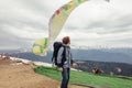 Young handsome man is looking at people who are fond of base jumping