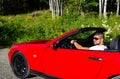 Young handsome man in luxurious car