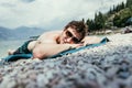 Young handsome man is lying on the beach, sun glasses