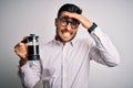 Young handsome man making coffee using french press coffeemaker over isolated background stressed with hand on head, shocked with Royalty Free Stock Photo