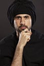 Young handsome man male in muslim turban. Close-up. Black background. Royalty Free Stock Photo