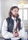 Young handsome man in medieval clothes with pistol Royalty Free Stock Photo