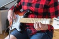 Young handsome man, musician, singer studying,practicing to play electric guitar at home,singing songs into microphone.Hobby, Royalty Free Stock Photo