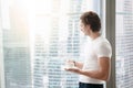 Young handsome man near full length window Royalty Free Stock Photo