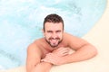 Young handsome man in outdoor jacuzzi on resort Royalty Free Stock Photo