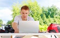 Attractive young man student using laptop outside Royalty Free Stock Photo