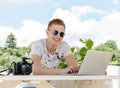 Attractive young man student using laptop outside Royalty Free Stock Photo