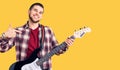 Young handsome man playing electric guitar pointing finger to one self smiling happy and proud Royalty Free Stock Photo