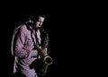 Young handsome man playing music on saxophone Royalty Free Stock Photo