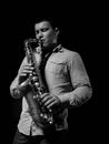 Young handsome man playing music on saxophone Royalty Free Stock Photo