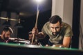 young handsome man playing in pool with friends Royalty Free Stock Photo