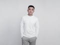 Young handsome man posing wearing white long sleeve t shirt with mockup concept
