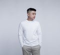 Young handsome man posing wearing white long sleeve t shirt with mockup concept