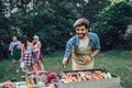Handsome man preparing barbecue for friends Royalty Free Stock Photo