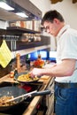 Young handsome man preparing dinner