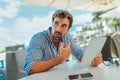 Young handsome man reading news on his tablet on the seaside Royalty Free Stock Photo