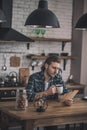 Young handsome man reading old letters at his kitchen Royalty Free Stock Photo