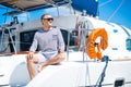 Young and handsome man relaxing on a sailing boat. Royalty Free Stock Photo