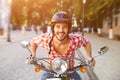 Young handsome man riding scooter Royalty Free Stock Photo