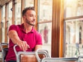 Young handsome man riding on tram or old bus in city