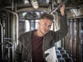 Young man riding on tram or old bus in city