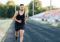 Young handsome man run on running track in a stadium Royalty Free Stock Photo